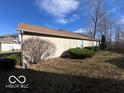 Side view of house showing vinyl siding and landscaping at 2907 Braxton Ct, Indianapolis, IN 46229