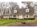 Brick ranch house with brown roof, white shutters, and landscaped lawn at 4205 Cranbrook Dr, Indianapolis, IN 46250