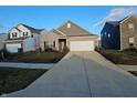 Ranch house with a driveway and neighboring houses visible at 4411 Ringstead Way, Indianapolis, IN 46235