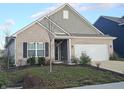 Brick ranch house with landscaping and a two-car garage at 4411 Ringstead Way, Indianapolis, IN 46235