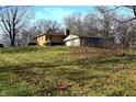 Back exterior view of a brick home with attached garage and grassy yard at 5155 Turkey Track Rd, Martinsville, IN 46151