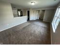 Spacious living room with plush carpeting and neutral-colored walls at 6215 E 11Th St, Indianapolis, IN 46219