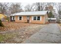 Brick ranch home with a driveway and landscaped yard at 6736 Carlsen Ave, Indianapolis, IN 46214