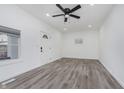 Bright living room with gray flooring, ceiling fan, and recessed lighting at 1127 E Kelly St, Indianapolis, IN 46203