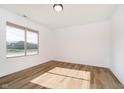 Spacious bedroom with large window and light wood flooring at 202 Asbury Dr, Anderson, IN 46013