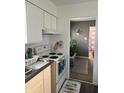 Efficient kitchen with white cabinets and electric range at 2307 N Catherwood Ave, Indianapolis, IN 46219