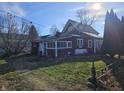 Rear view of a red house with a screened porch and a yard at 2402 N B St, Elwood, IN 46036