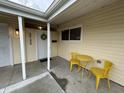 Covered porch with yellow metal table and chairs at 2732 Desoto Way, Columbus, IN 47203