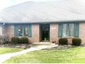 Brick ranch home with green shutters, landscaping, and a walkway at 316 Northpointe Ct, Danville, IN 46122