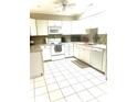 Bright kitchen with white cabinets, tile floor, and modern appliances at 316 Northpointe Ct, Danville, IN 46122