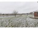 Spacious backyard with pond view and light snow at 4208 E Epler E Ave, Indianapolis, IN 46237