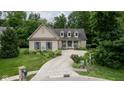 House with driveway and landscaping nestled in a wooded area at 4655 Winterstill Rd, Zionsville, IN 46077