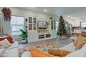 Spacious living room with a large TV, Christmas tree, and comfy sofas at 5645 E 16Th St, Indianapolis, IN 46218