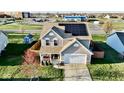 Two-story house with solar panels, a fenced backyard, and a nearby playground at 672 Rocky Meadow Dr, Greenwood, IN 46143