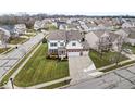 Two-story home situated on a tree-lined street in a residential neighborhood at 7648 Three Arch Overlook, Noblesville, IN 46062