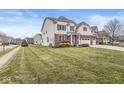 Two-story home with a two-car garage, nicely landscaped yard, and brick accents at 7648 Three Arch Overlook, Noblesville, IN 46062