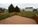 Spacious deck overlooking backyard with green lawn and trees at 8435 Smithfield Ln, Indianapolis, IN 46237