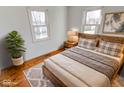 Bedroom with hardwood floors and a rustic wooden bed frame at 9155 Melrose Ct, Indianapolis, IN 46239