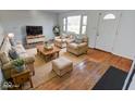 Spacious living room featuring hardwood floors and ample seating at 9155 Melrose Ct, Indianapolis, IN 46239