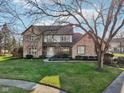 Two-story brick house with a tree and manicured lawn at 1451 Clearwater Ct, Carmel, IN 46032