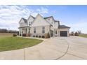 Two-story home showcasing a side view of the garage and driveway at 16222 Browning Ct, Fishers, IN 46037