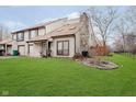 Attractive two-story townhome with a stone fireplace and well-maintained lawn at 2510 Hideaway N Dr, Indianapolis, IN 46268