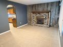 Living room features a brick fireplace and wood accent wall at 534 Mooreland Dr, Whiteland, IN 46184