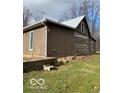 Side view of log cabin showcasing wood siding and stone accents at 5967 S Lick Creek Rd, Morgantown, IN 46160