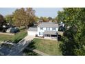 Two-story house on a tree-lined street, with a driveway and yard at 6031 S Eaton Ave, Indianapolis, IN 46259