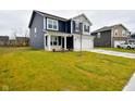 Two-story house with navy blue siding, white garage door, and a well-maintained lawn at 6329 Basden Dr, Indianapolis, IN 46221