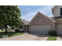 Exterior view of a brick condo with a two car garage at 803 Jordan Dr, Greenwood, IN 46143