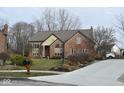 Brick house with a landscaped yard and driveway at 8429 Admirals Cv, Indianapolis, IN 46236