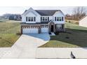 Two-story house with white siding, brick accents, and a three-car garage at 2400 Oakmont Dr, Plainfield, IN 46168