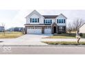 Two-story house with white siding, brick accents, and a three-car garage at 2400 Oakmont Dr, Plainfield, IN 46168