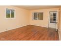 Living room with hardwood floors and large windows at 3322 N Whittier Pl, Indianapolis, IN 46218