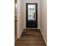 Bright entryway with dark hardwood floors and a black front door at 3923 Holly Brook Dr, Westfield, IN 46062