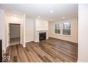 Spacious Gathering room with fireplace, hardwood floors, and large windows at 3923 Holly Brook Dr, Westfield, IN 46062