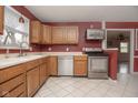 Galley kitchen with stainless steel appliances and wood cabinets at 8105 Allisonville Rd, Indianapolis, IN 46250