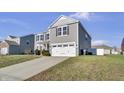 Two-story gray house with white garage door and landscaping at 2034 Buckthorn Dr, Columbus, IN 47201