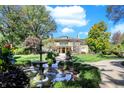 Elegant home with a fountain and beautifully landscaped front yard at 4621 N Meridian St, Indianapolis, IN 46208