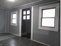 Dark grey walls, dark floors, and a dark brown door with windows at 1314 Arrow Ave, Anderson, IN 46016