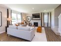 Spacious living room with hardwood floors, fireplace, and large windows at 3255 Wetherby Pl, Danville, IN 46122