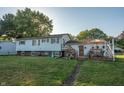 Home's back deck with patio furniture and landscaping at 801 Spring Valley Dr, Indianapolis, IN 46231