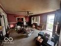 Living room with wood-paneled walls and a wood-burning stove at 5233 S Vine St, Columbus, IN 47201