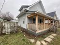 Another side view of the gray house, highlighting its porch and walkway at 1048 N Mount St, Indianapolis, IN 46222