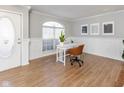 Bright home office with wood-look floors and built-in shelving at 12551 Brookhaven Dr, Fishers, IN 46037