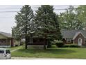 Two-story house with a yard and neighboring houses visible at 3949 English Ave, Indianapolis, IN 46201