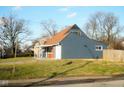 Side view of a charming blue ranch home with a fenced yard at 4001 N Catherwood Ave, Indianapolis, IN 46226