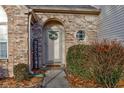 Inviting front entry with brick facade and a charming wreath at 6420 Hunters Green Ct, Indianapolis, IN 46278