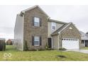 Two-story home with brick and siding accents, a white garage door, and a neat lawn at 2539 Shadowbrook Trce, Greenwood, IN 46143